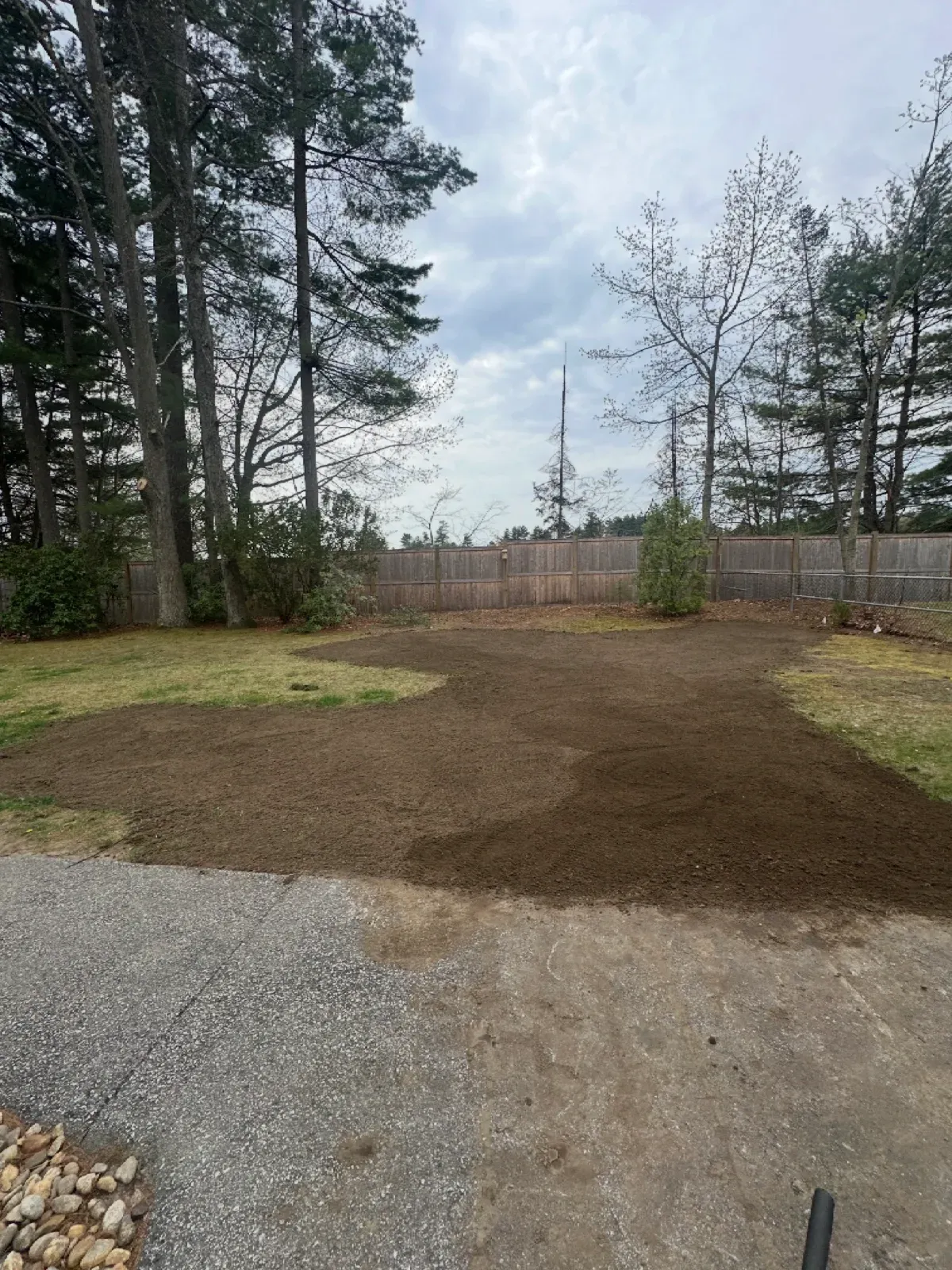 Finished graded area next to a gravel driveway