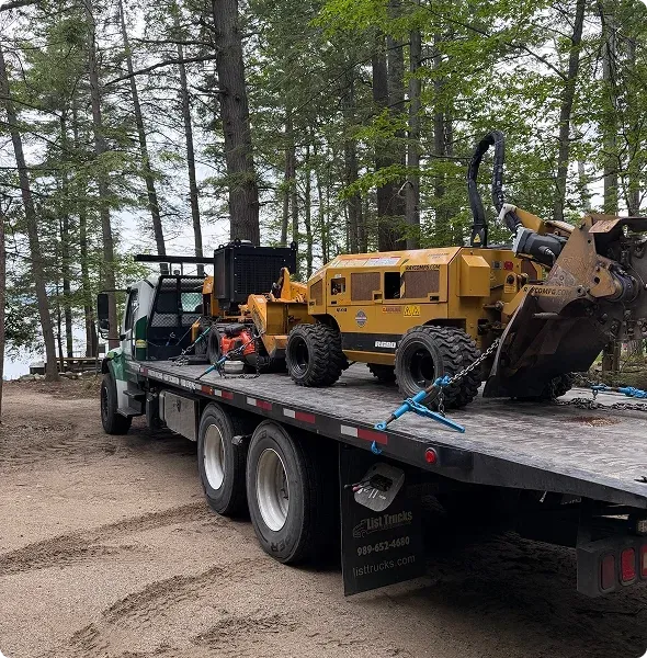 Stump grinder loaded on a flatbed truck ready for transport