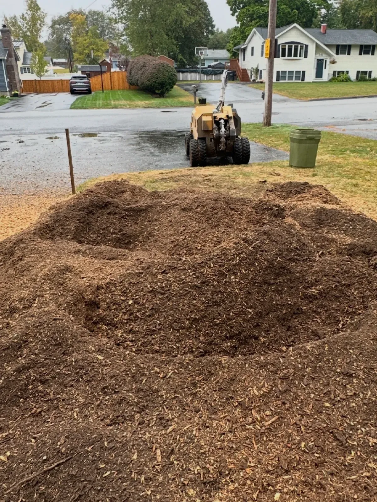 Pile of wood chips left after grinding a stump near a street